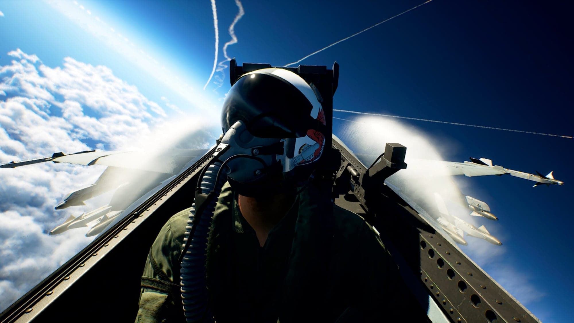 Capture d'Ace Combat 8: Wings of Theve : un pilote casqué et masqué dans le cockpit de son avion de chasse, au-dessus d'une mer de nuages, avec des missiles sous les ailes et des traînées de condensation dans le ciel